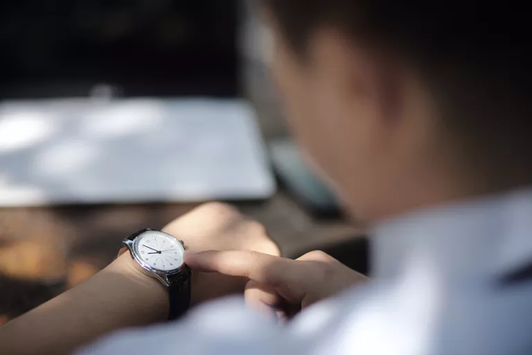 Businessman checking the time on his watch